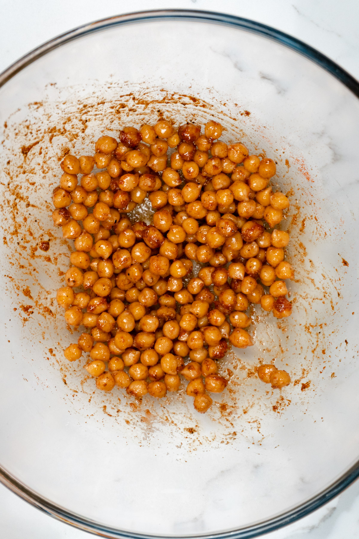 chickpeas mixed with spices in a glass bowl