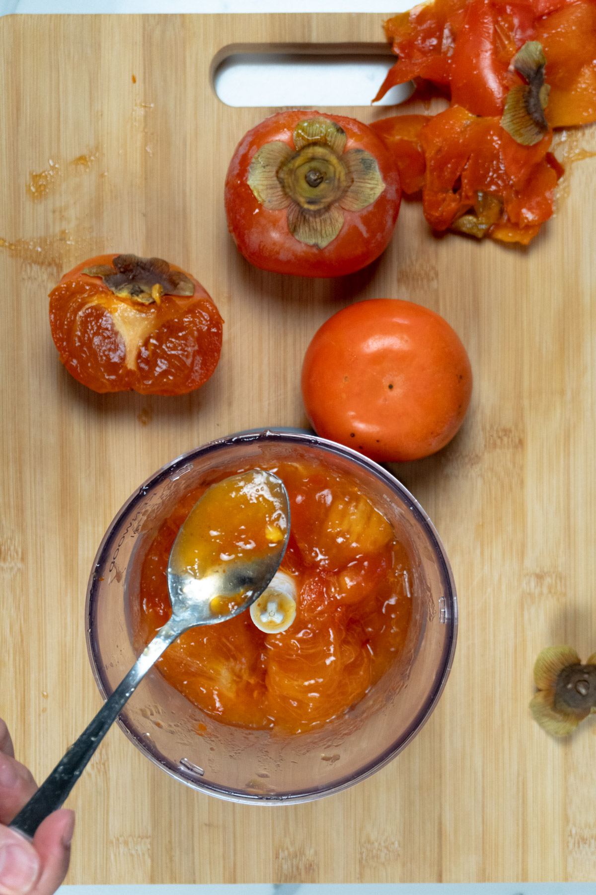 placing persimmon flesh into a blender