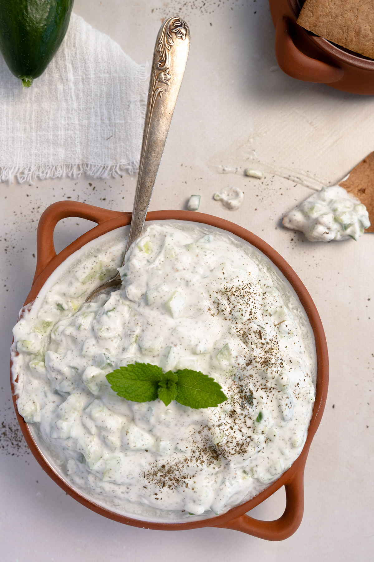 cucumber yogurt salad in a terracotta plate