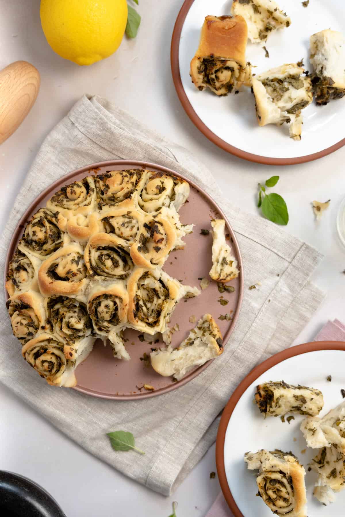 oregano bread pulled apart on a pink tray