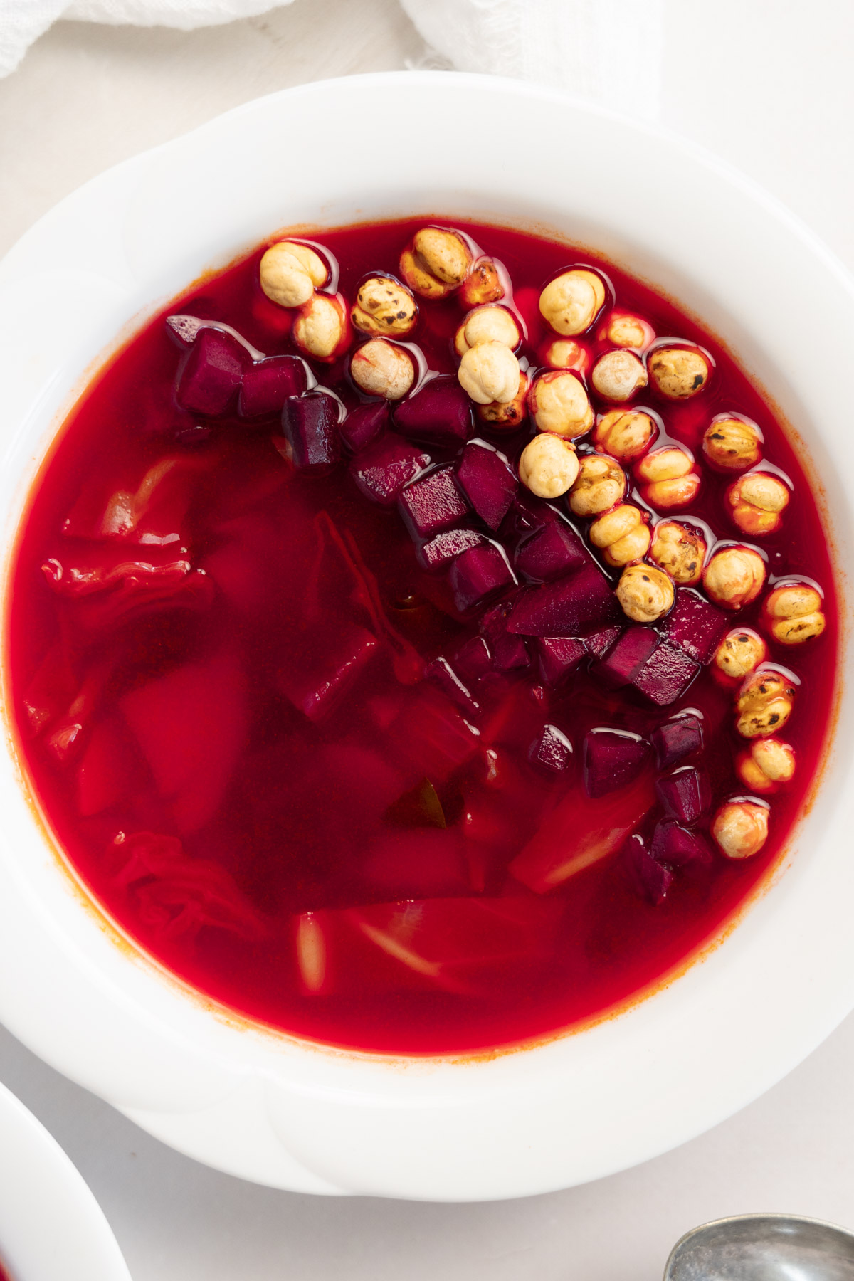 beet soup up close with chickpeas as garnish