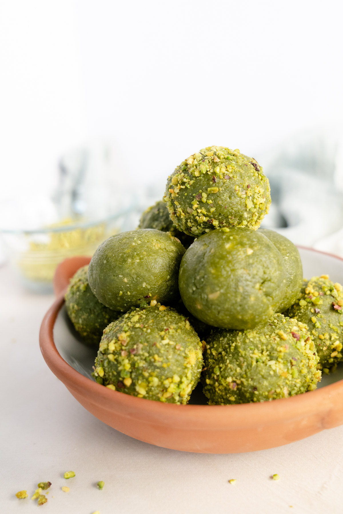 a stack of matcha balls in a brown bowl