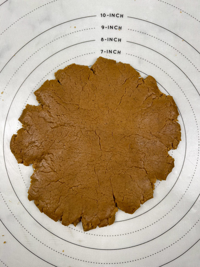 vegan gluten free gingerbread dough flattened onto a silicone mat