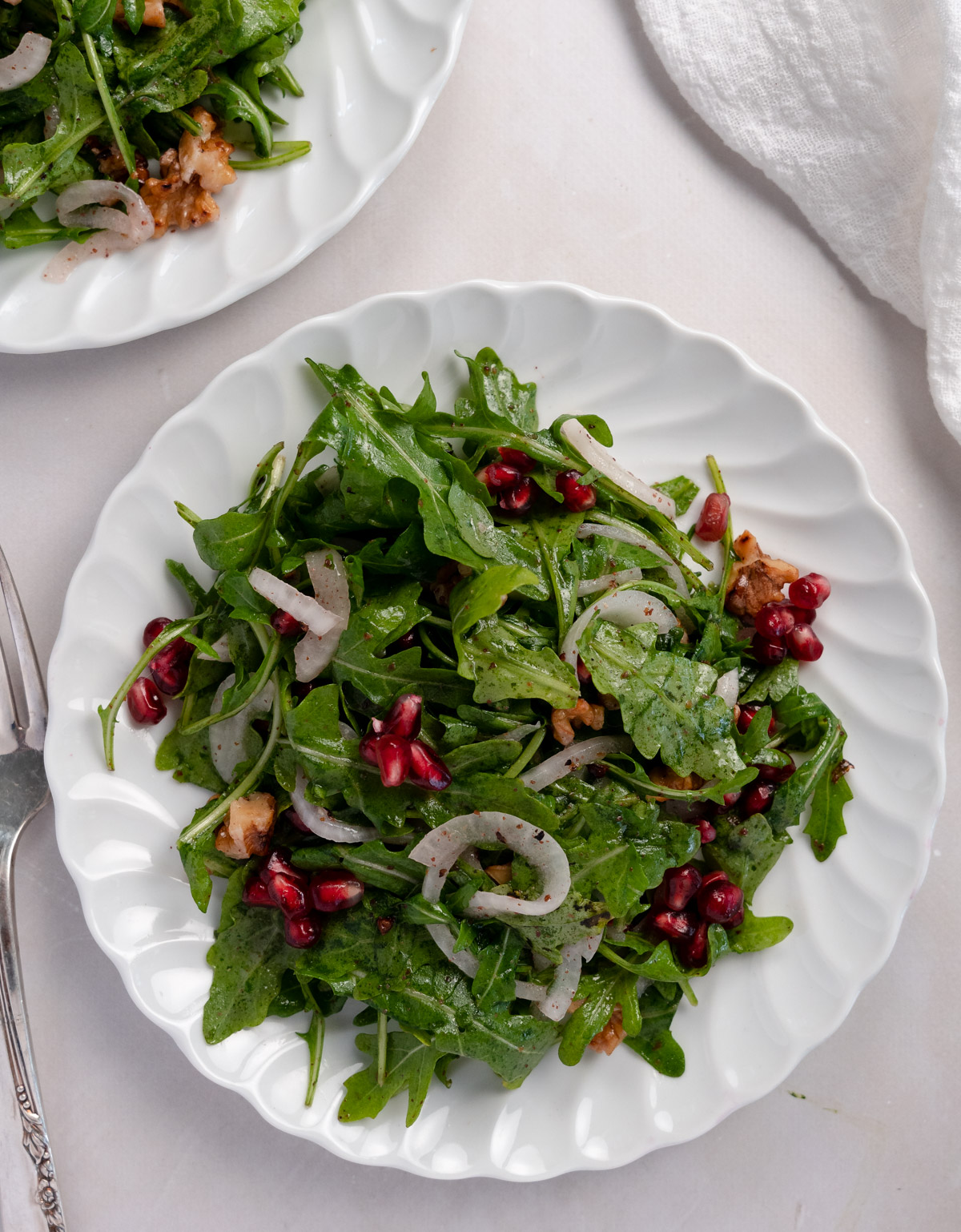 white plate with rocket salad