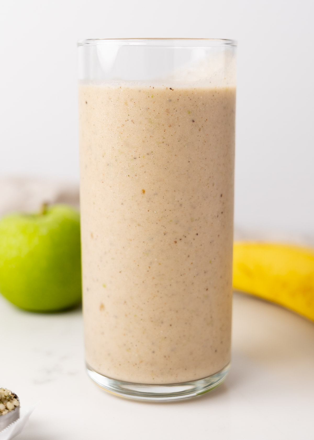 banana apple smoothie in a glass cup