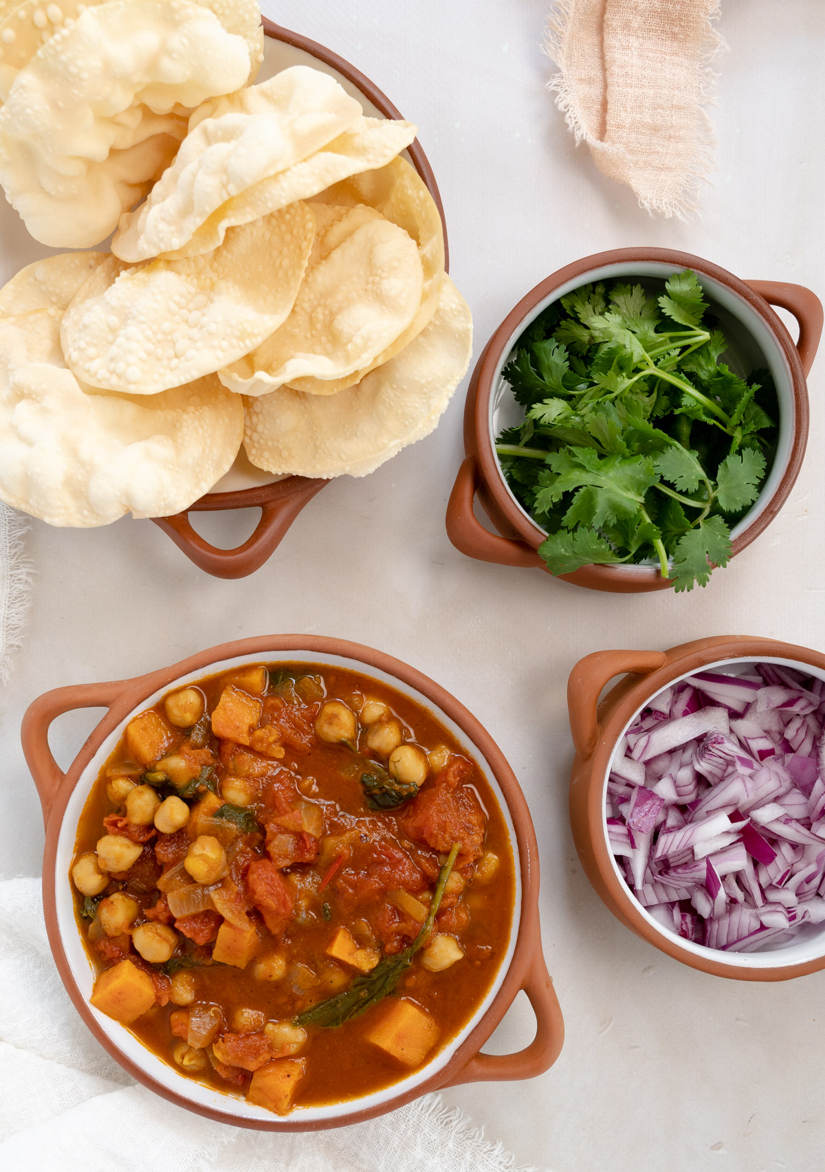 vegetable curry with a side of papadums, coriander and onion