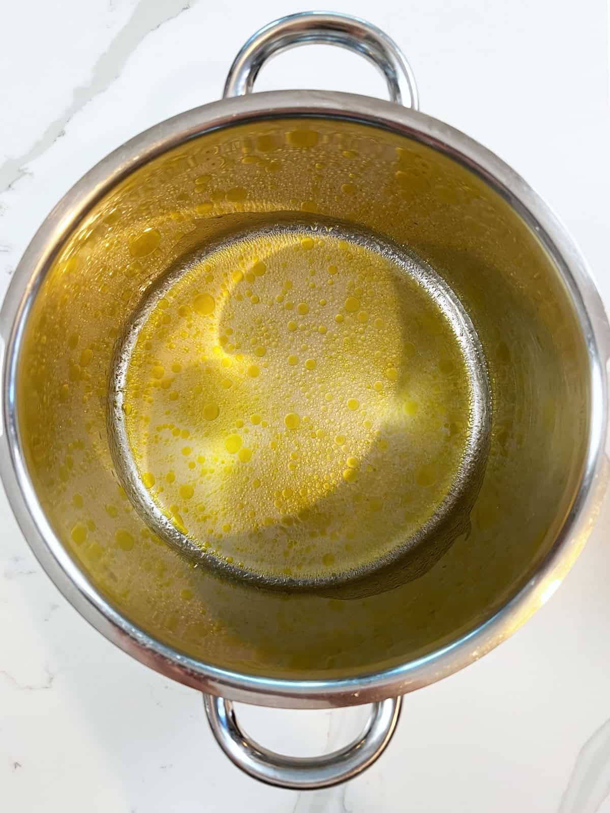lemon and olive oil on the bottom of a pot