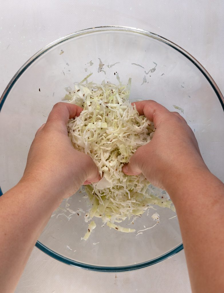 massaging shredded cabbage