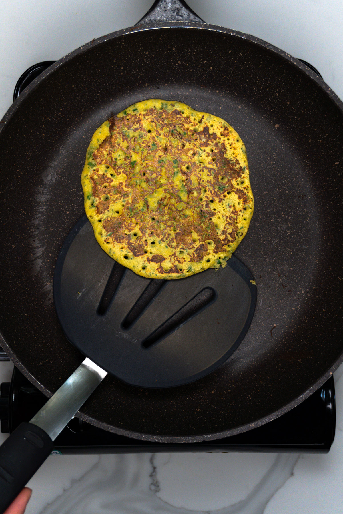 taking the omelette out of the fry pan with a spatula