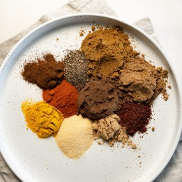 different spices in a white plate