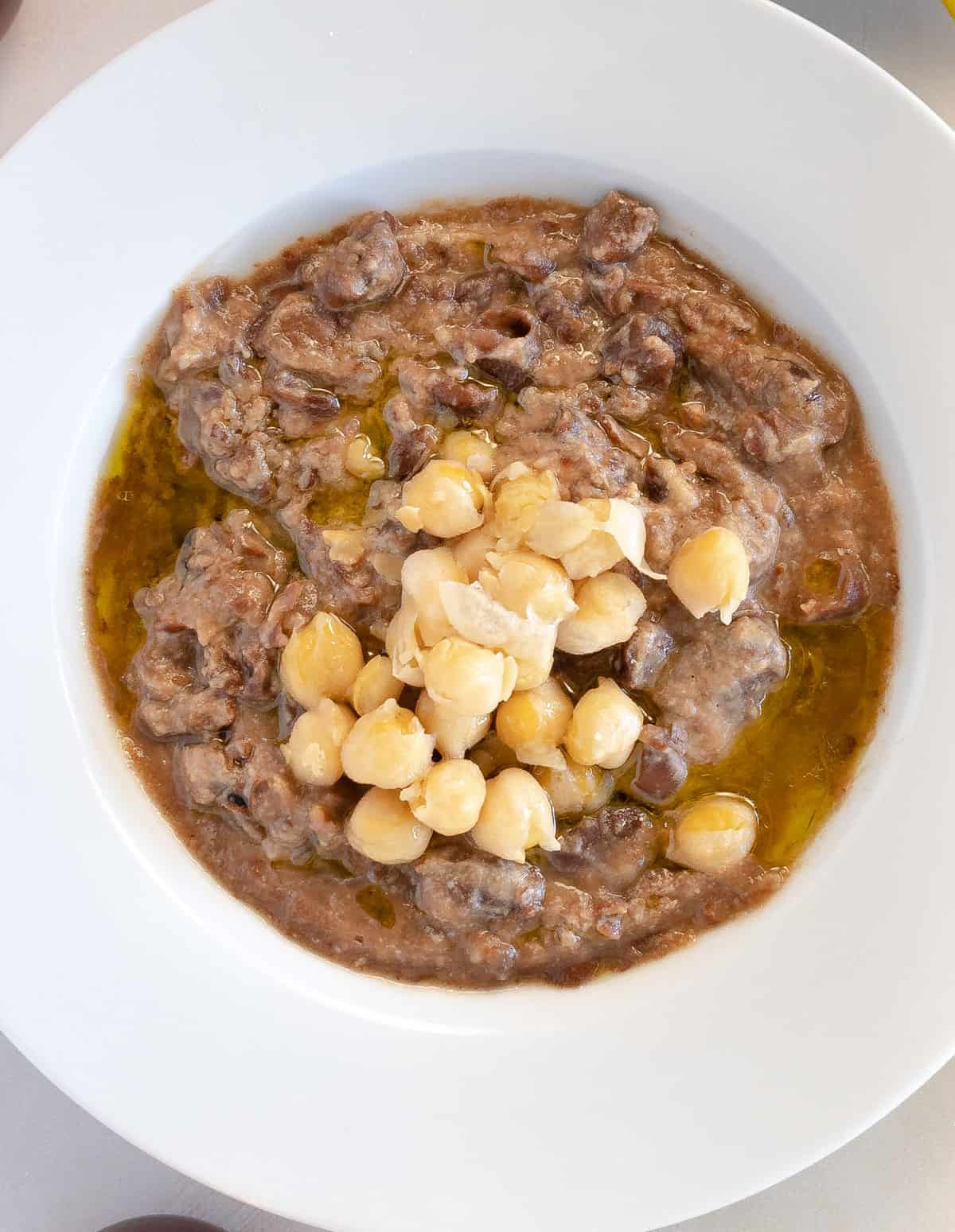 plain cooked fava beans topped with chickpeas and olive oil