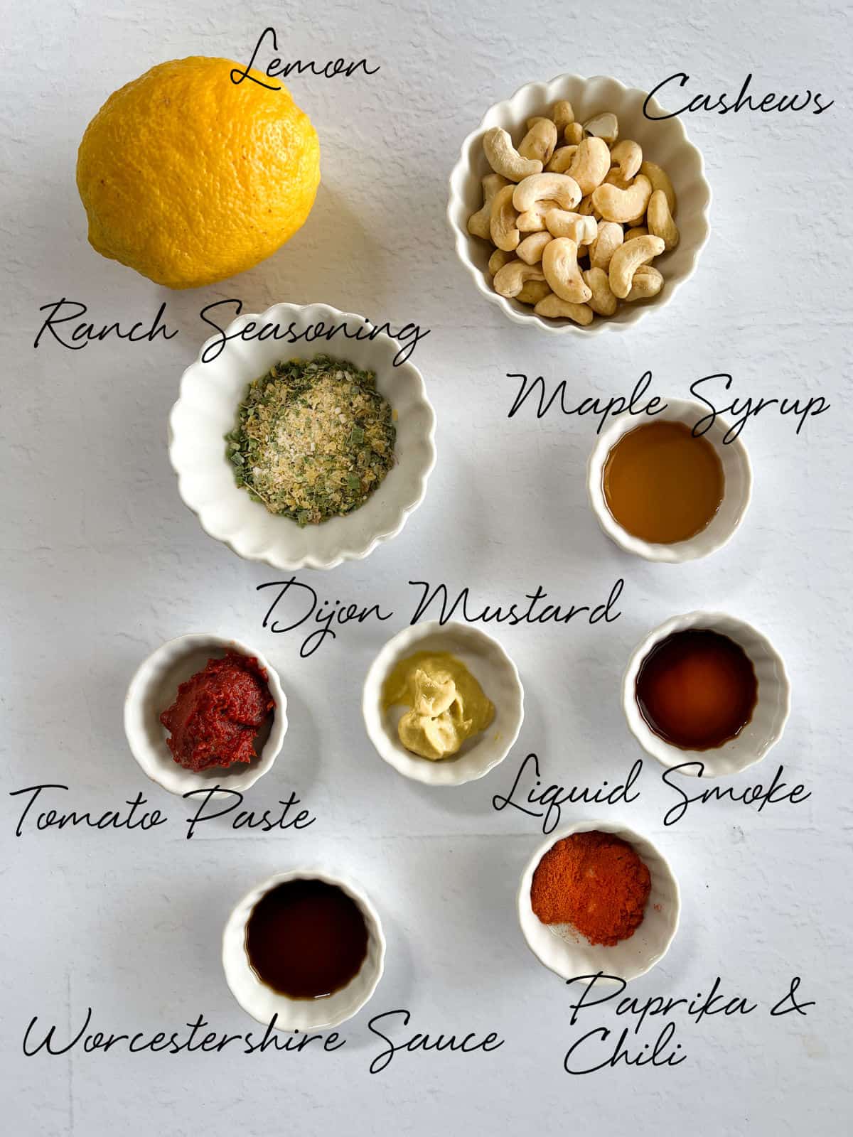 a lemon, cashews, ranch seasoning and other reddish sauces laid out