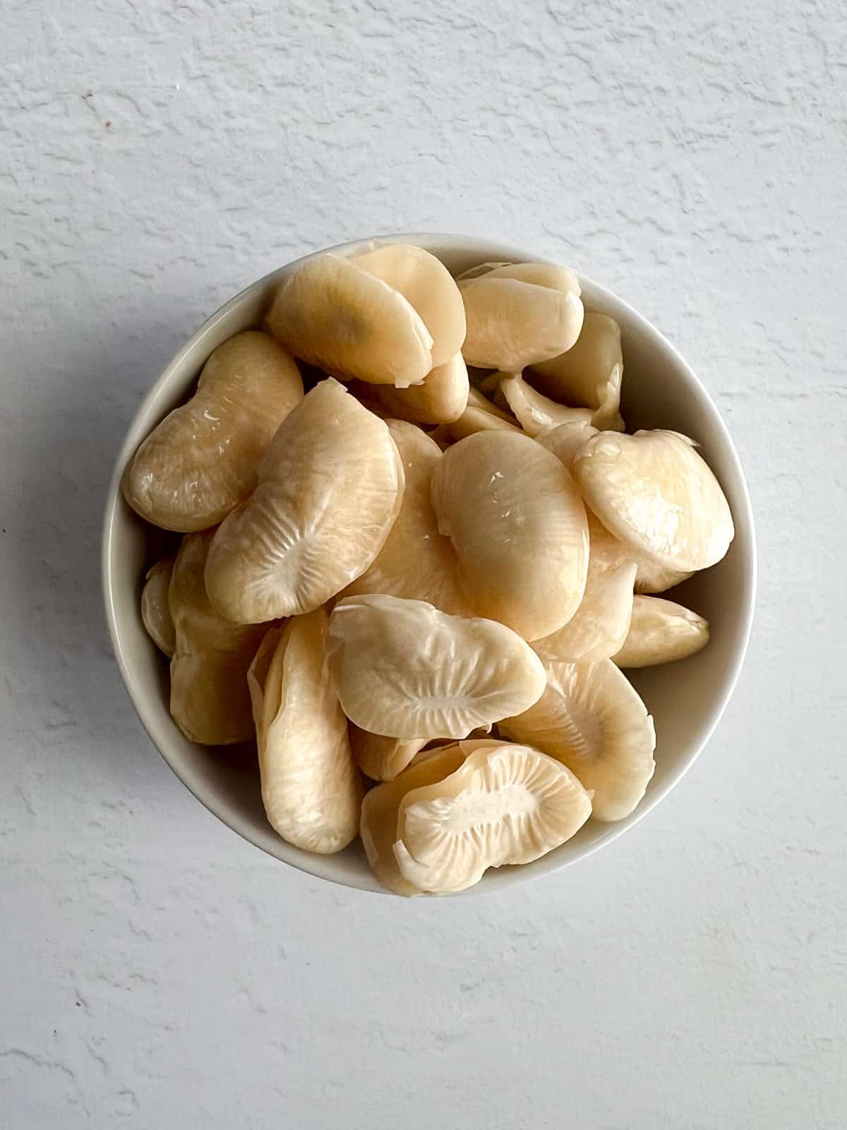 soaked lima beans in a white bowl