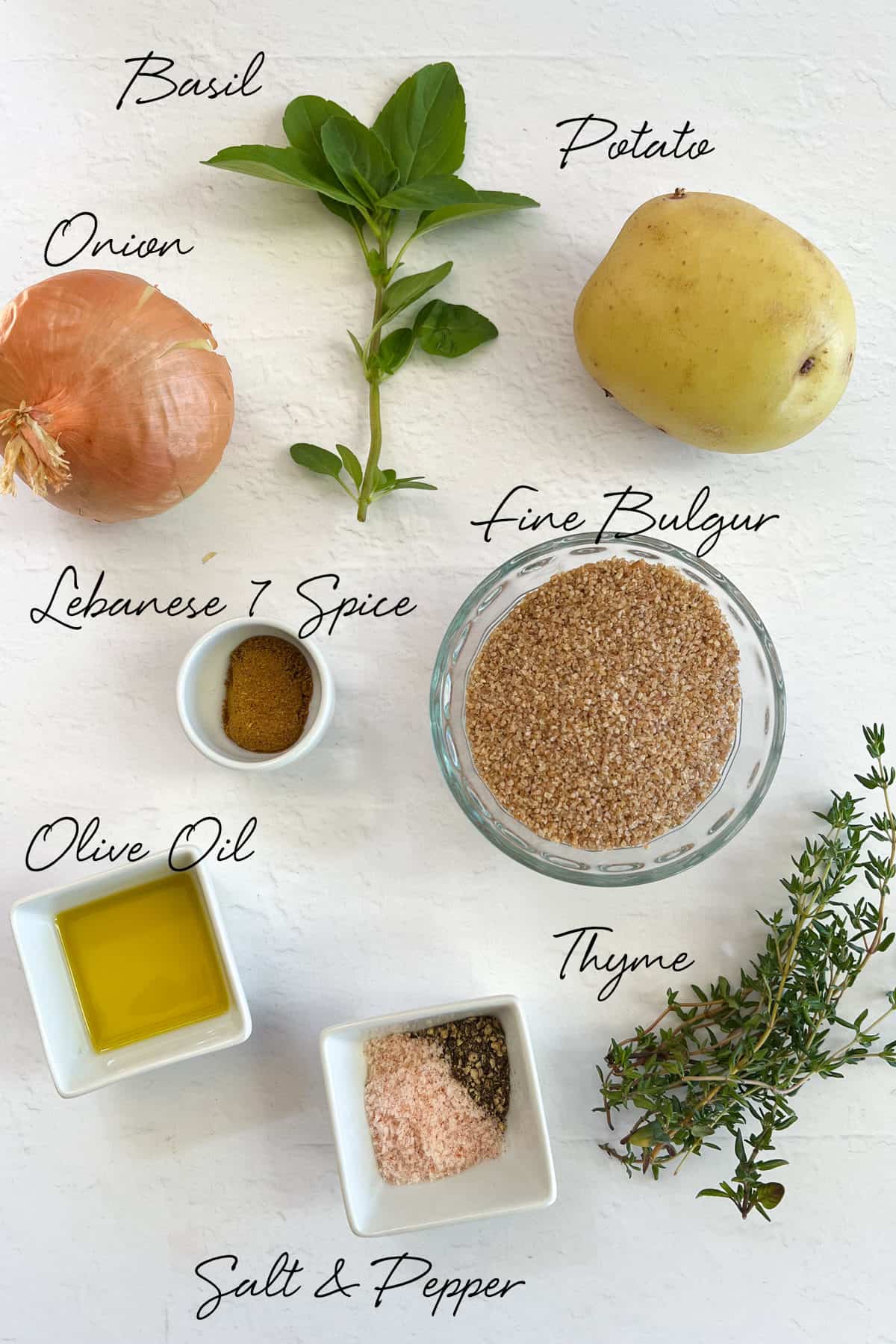 basil, onion, potato, burghul, oil, thyme, 7 spice, salt and pepper laid out on a white bench