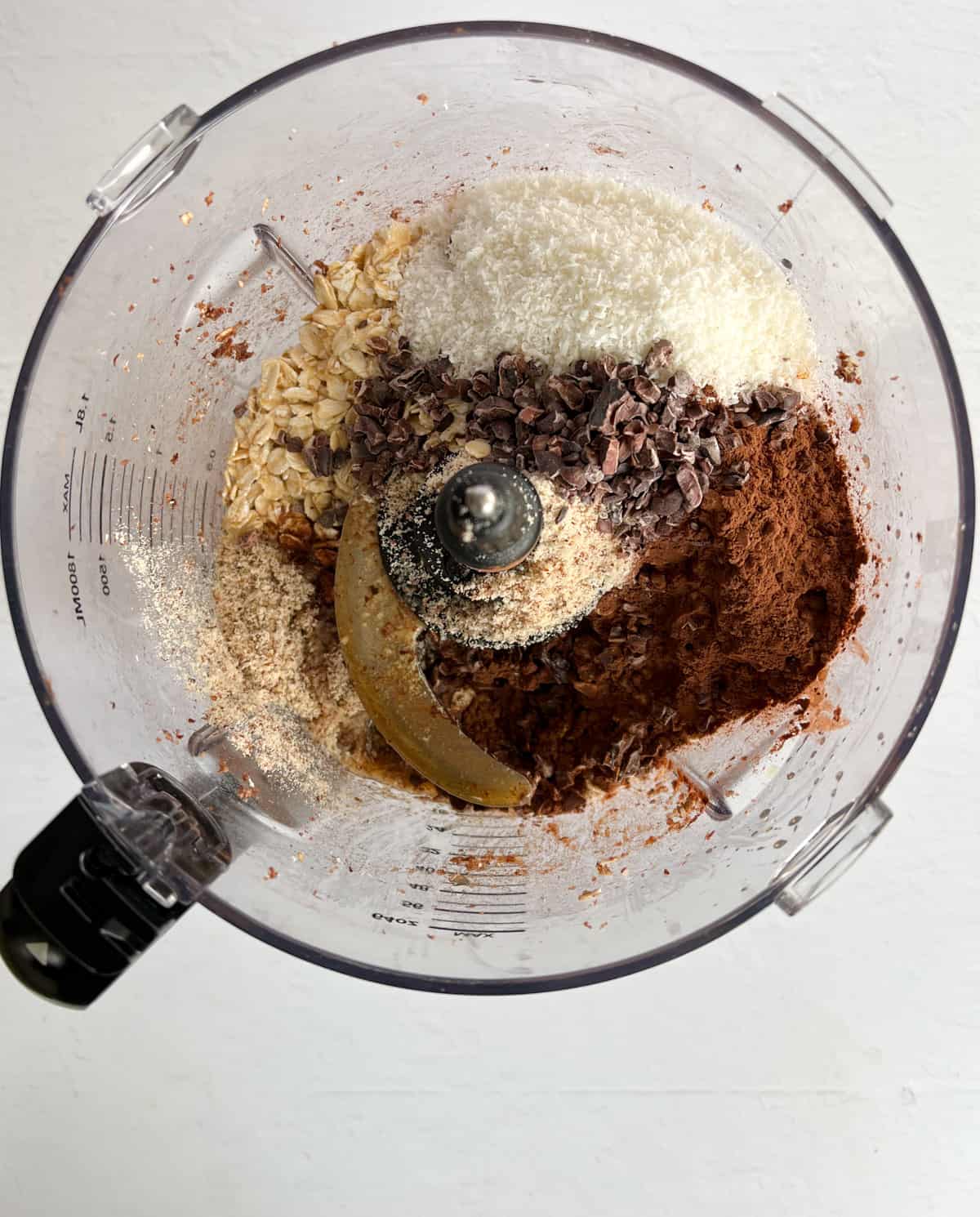 bliss ball ingredients in a food processor bowl before processing