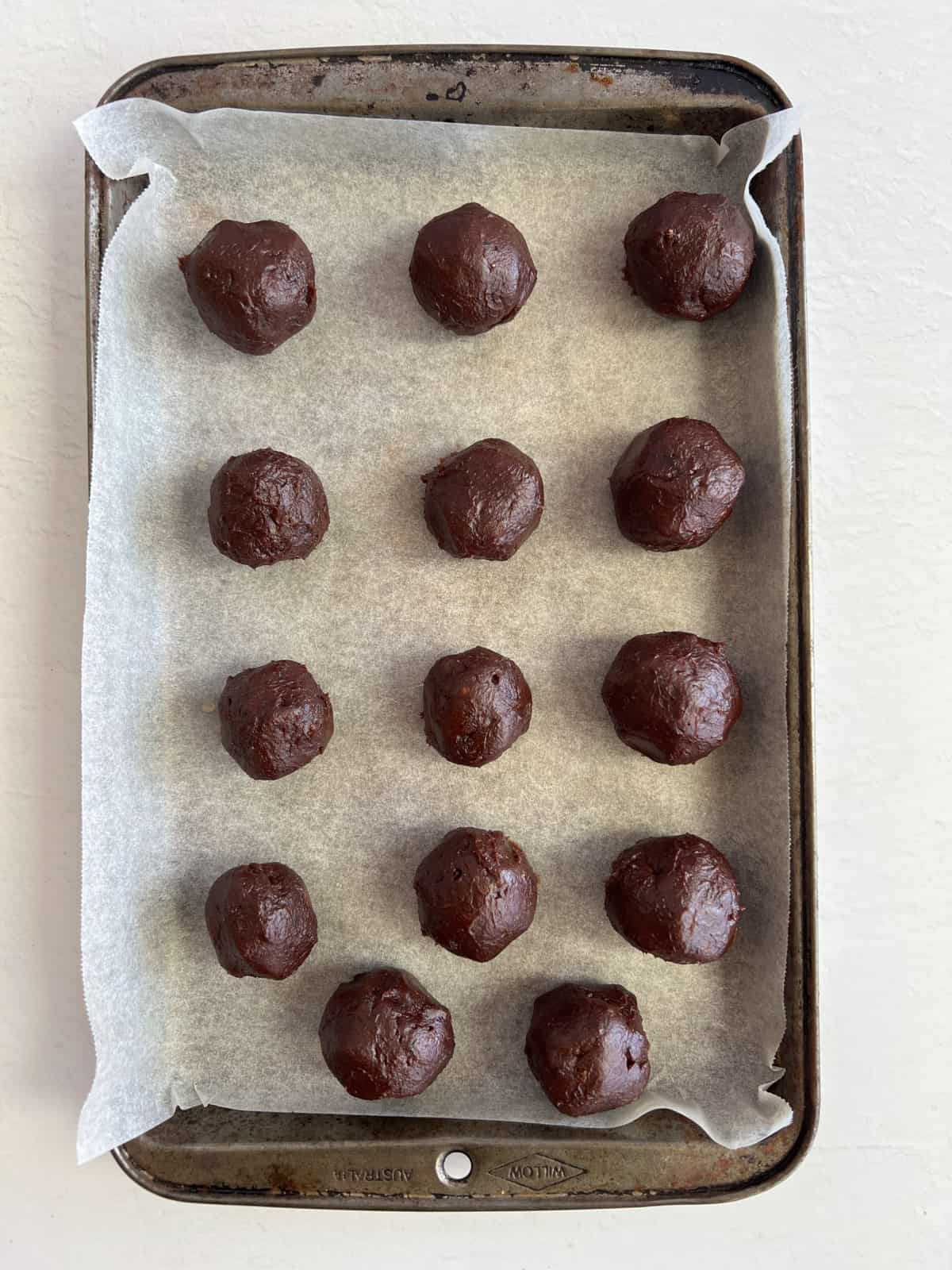 uncoated brown balls in a tray