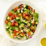 a white bowl filled with chopped colourful vegetables as a salad