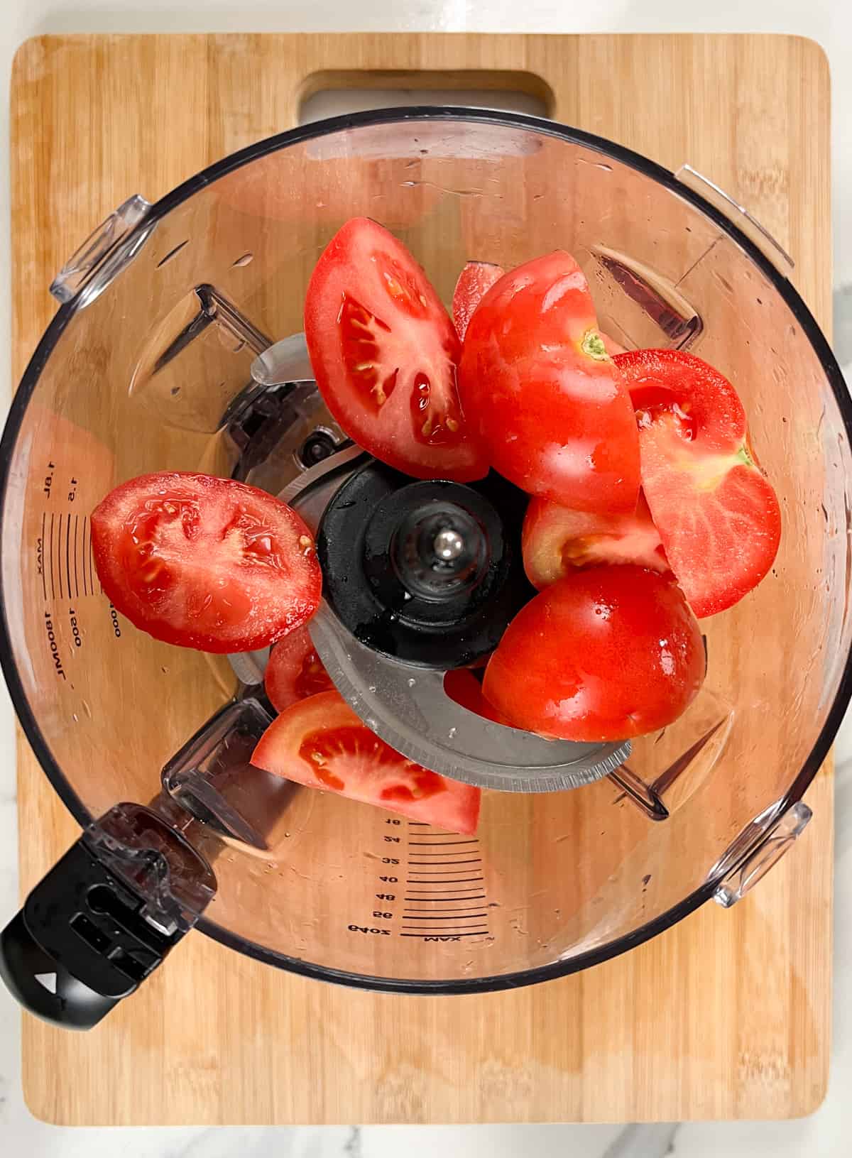 wedges of tomato in a food processor jug