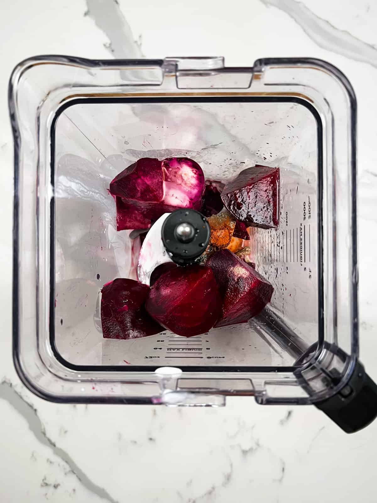 cut up beetroot pieces with liquid in a blender jug