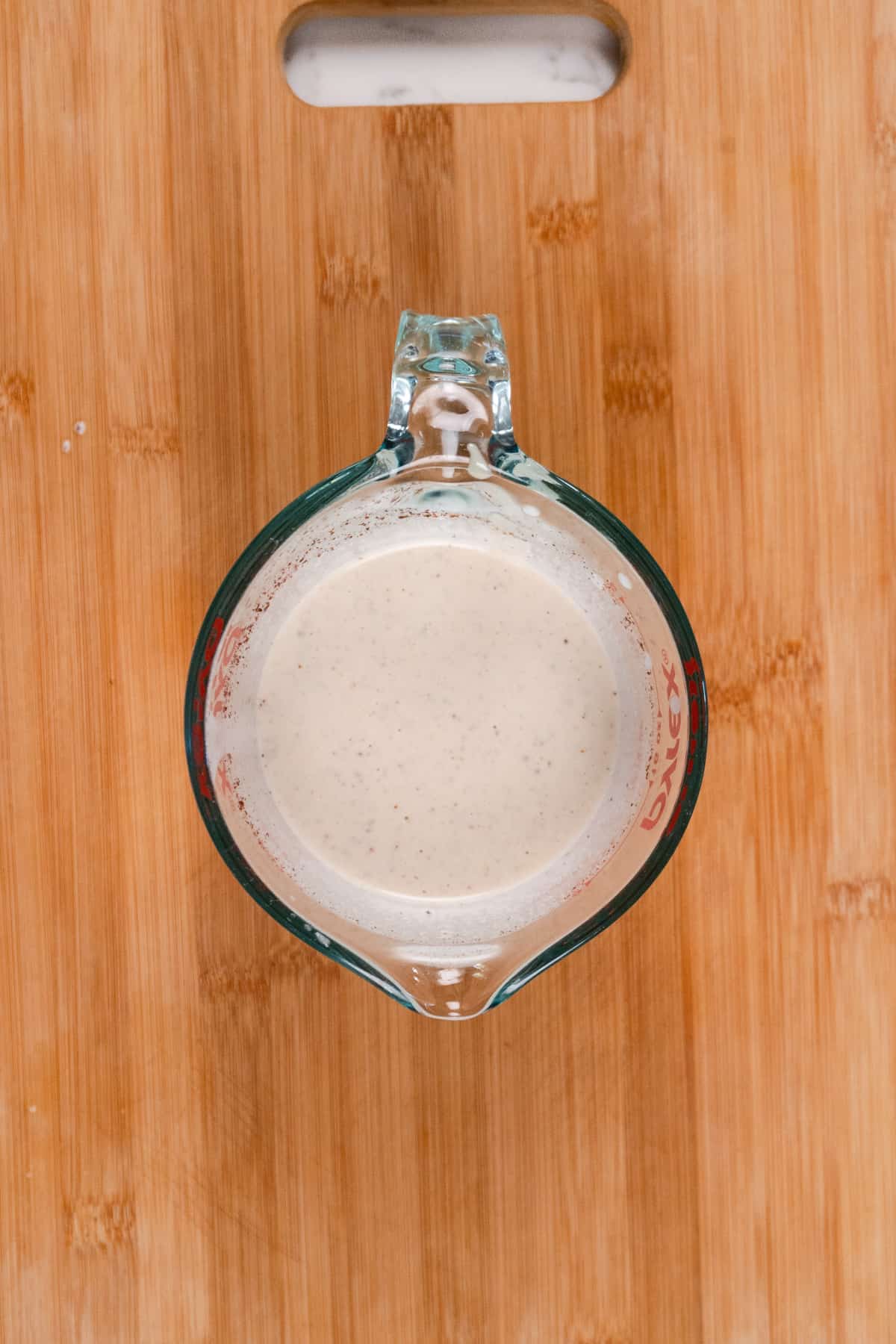 whiteish dressing in a glass jug