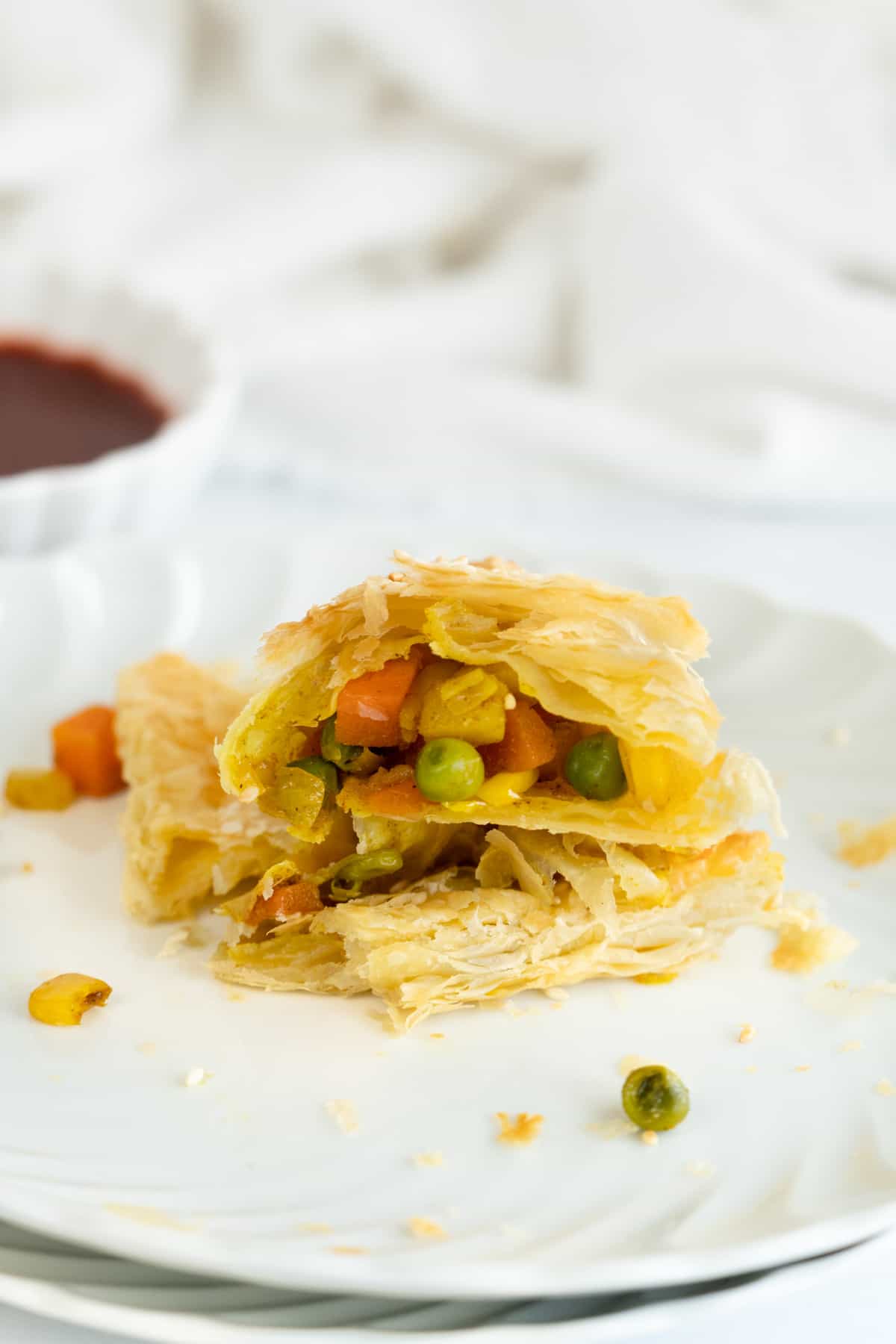 a torn pastry with the vegetable filling showing