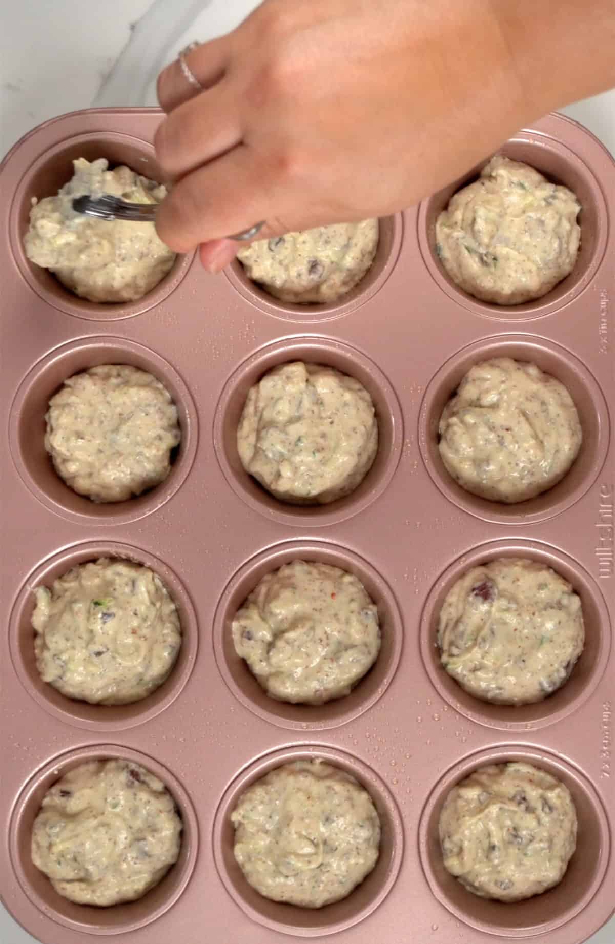 batter in a 12 muffin tray