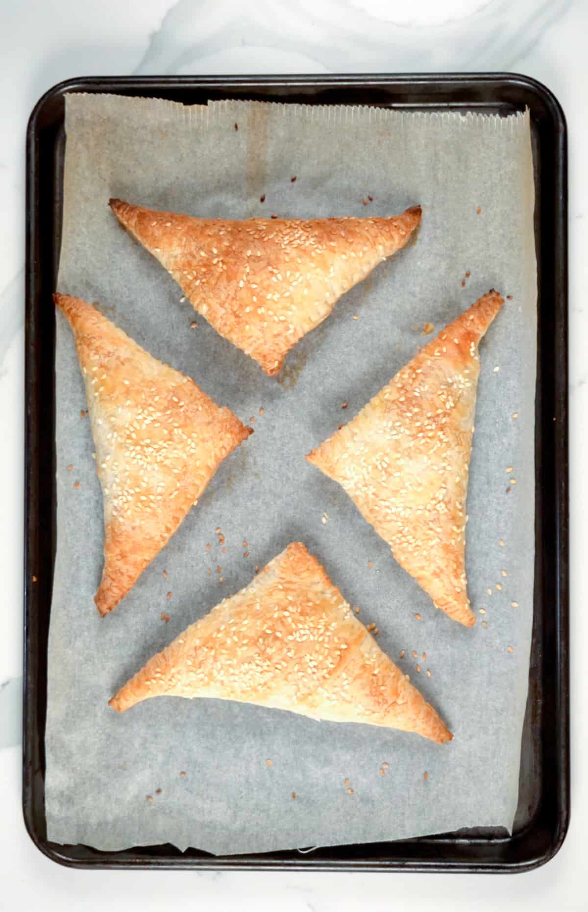 four cooked triangle pastries