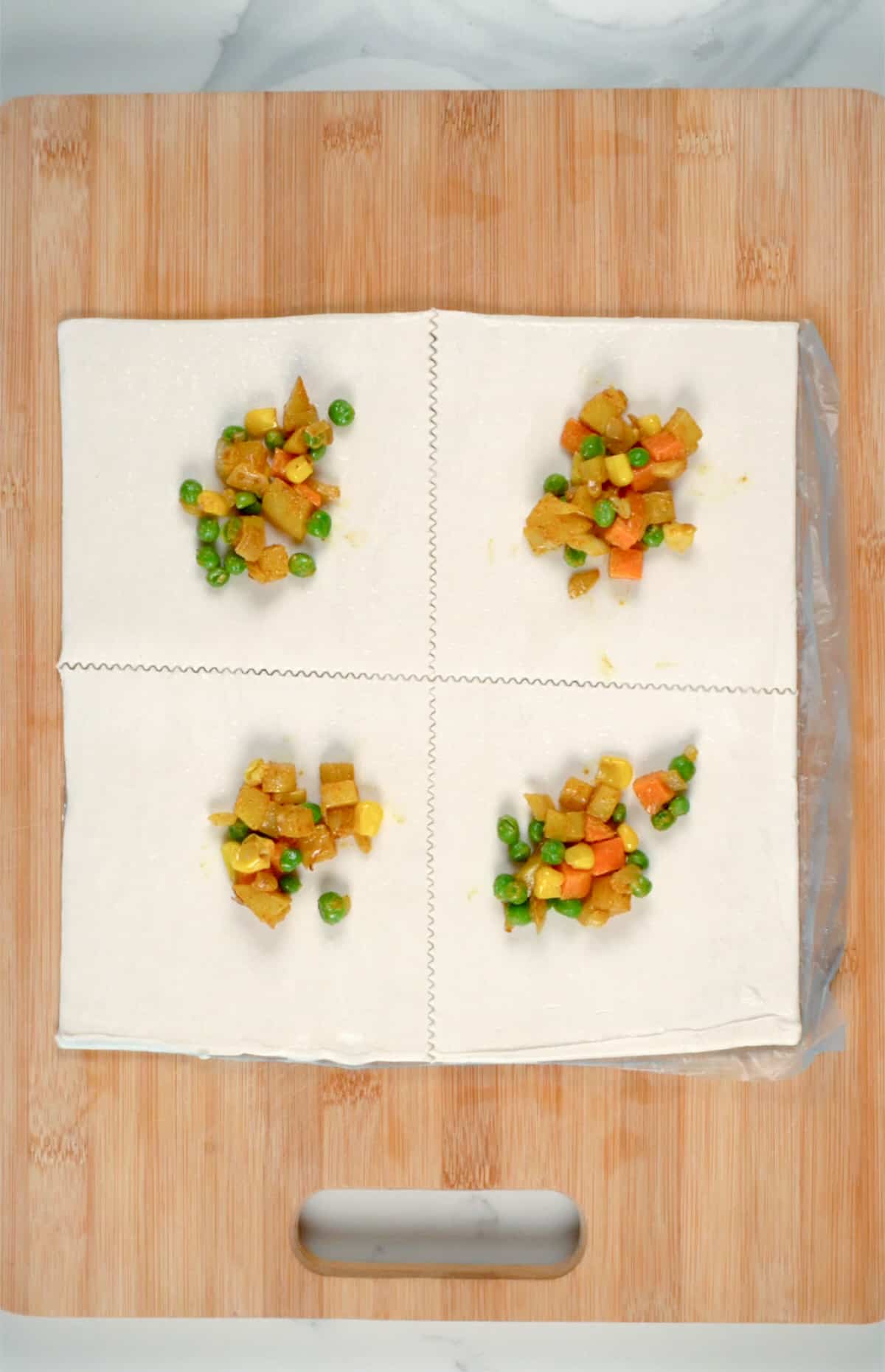 a square puff pastry sheet cut into four with filling in each section