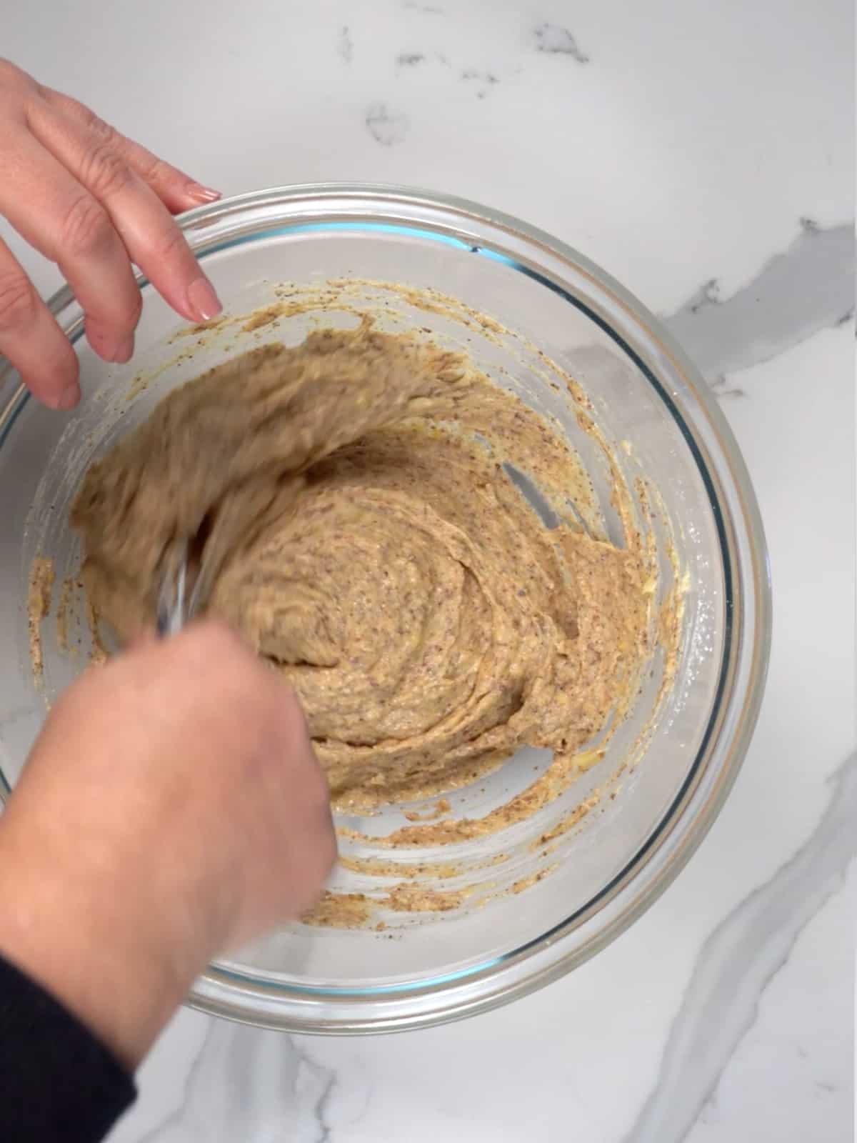 mixing batter in a glass bowl