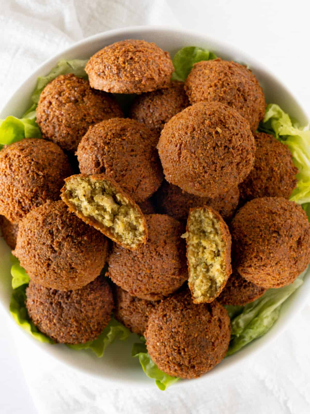 a bowl of brown falafel balls