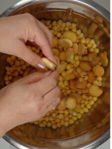 broadbeans and chickpeas soaking in a bowl of water