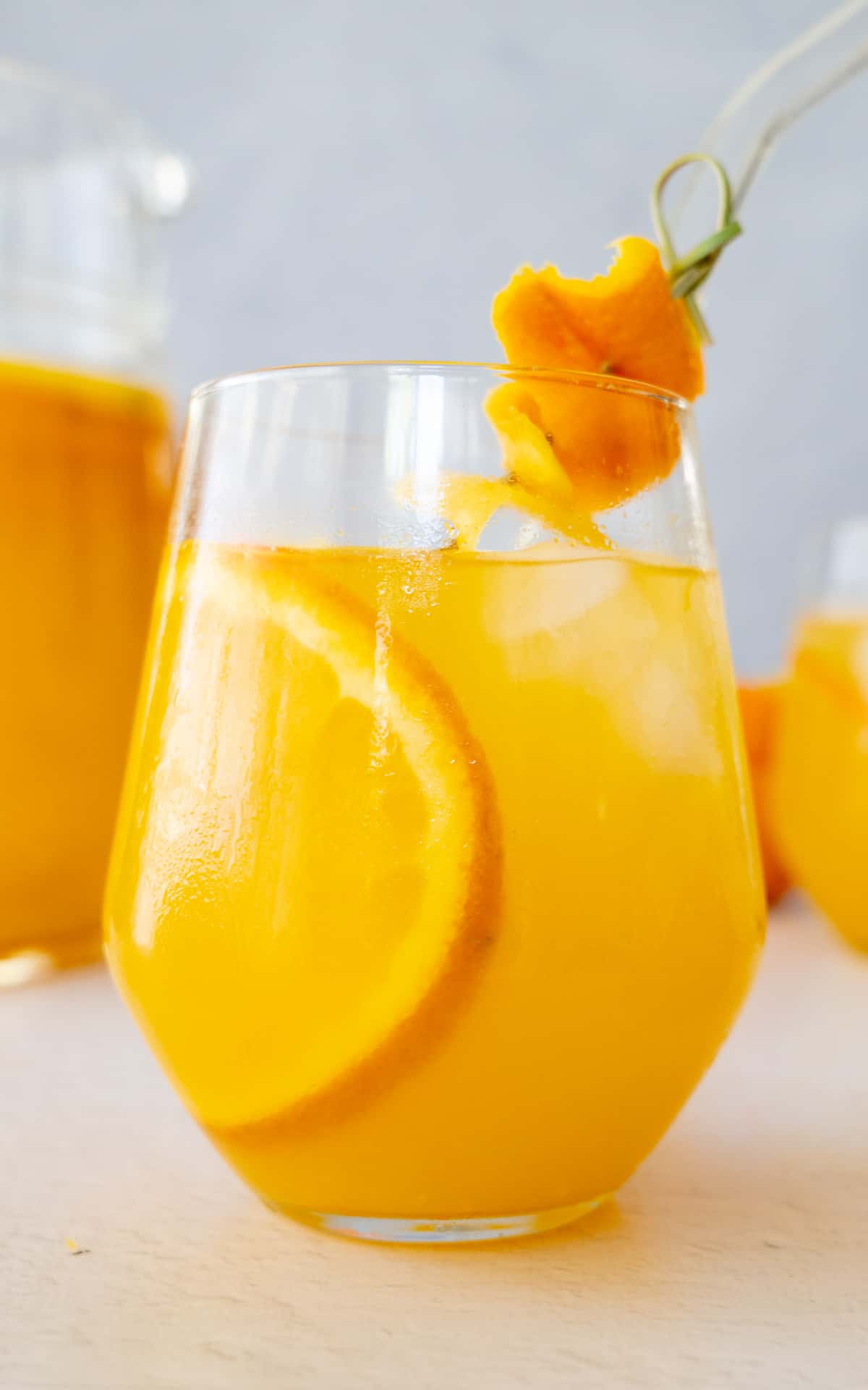 a cup of orangeade with a slice of orange