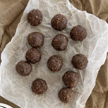 chocolate peanut butter balls laid out on parchment paper