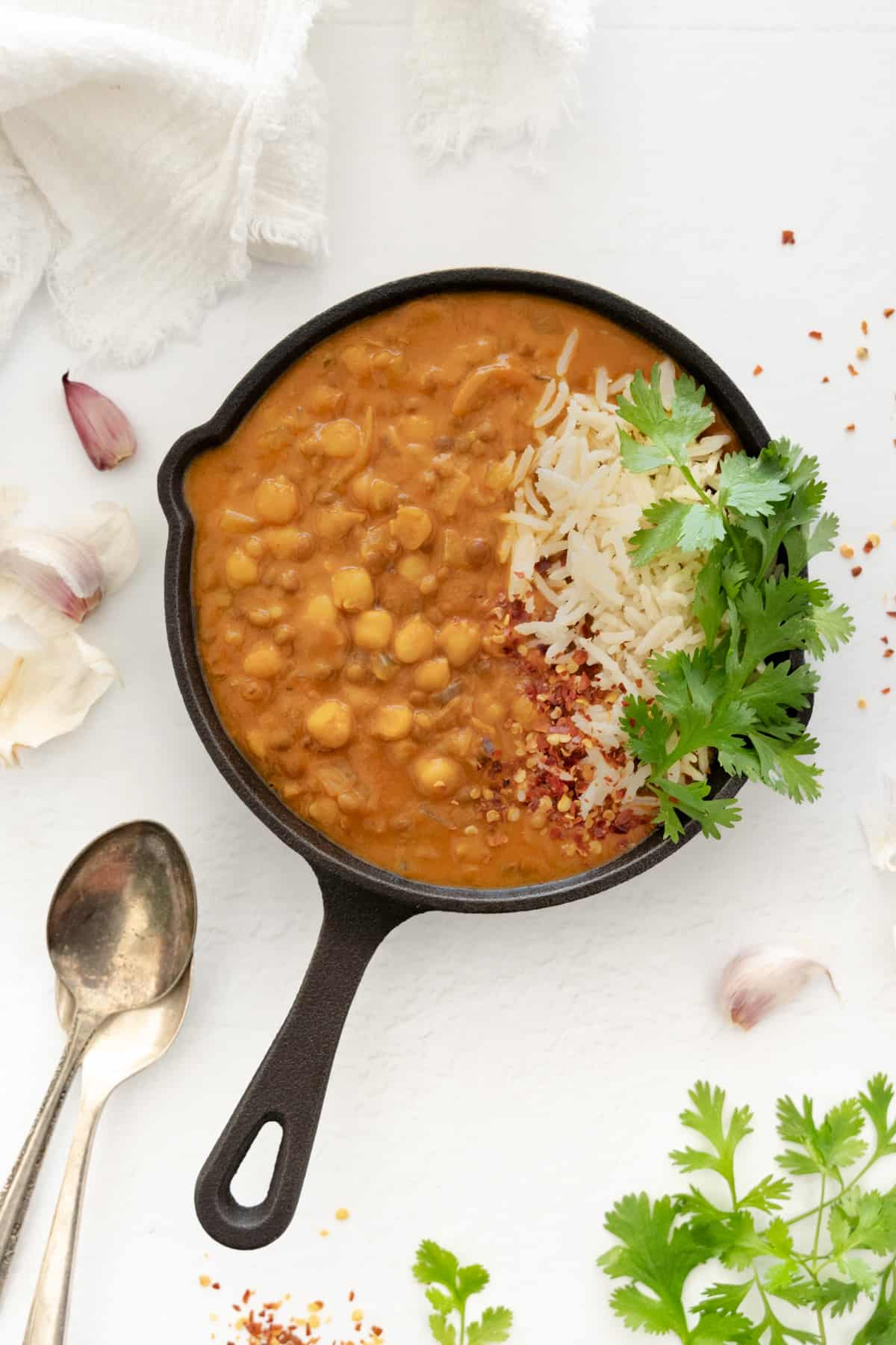 chickpea lentil curry in a pan with rice