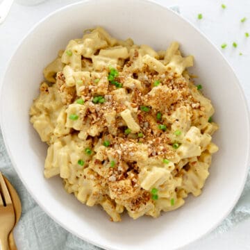 a white bowl with creamy plant based mac and cheese