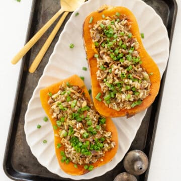 two stuffed butternut squash halves filled with lentils and rice