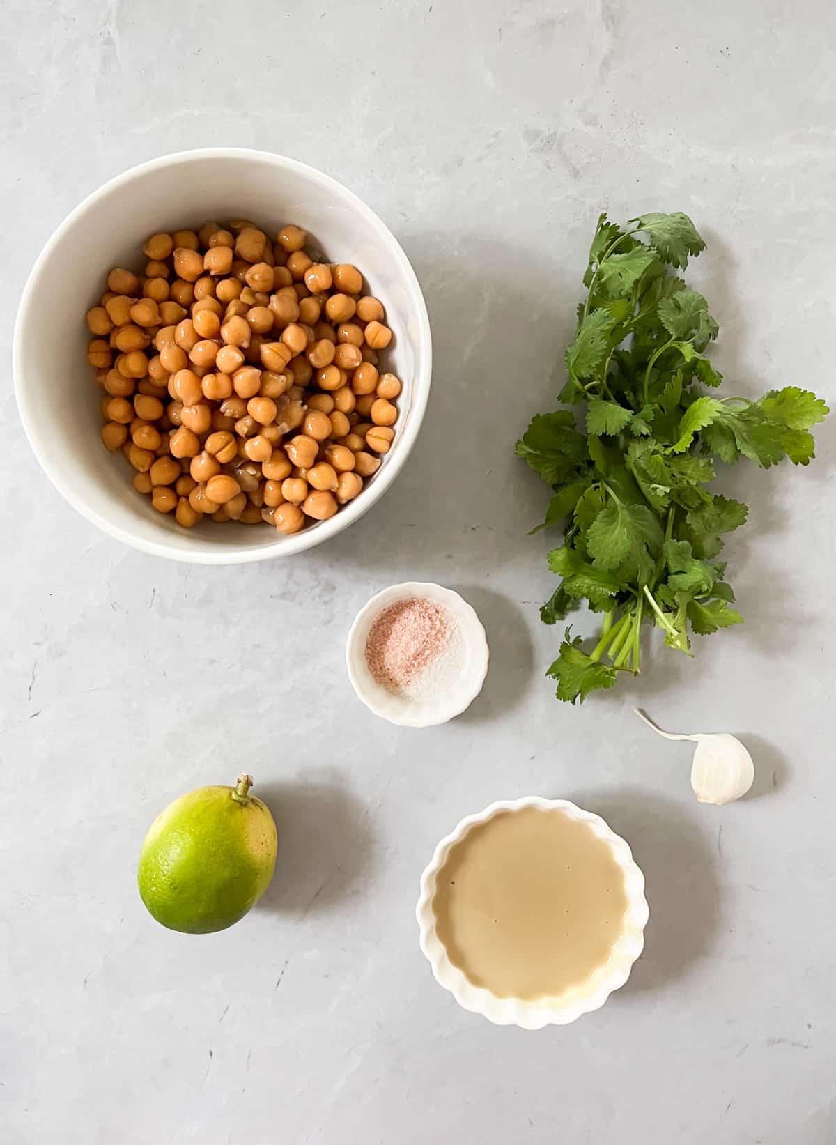 chickpeas, cilantro, salt, tahini, lime and garlic laid out