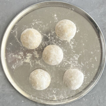 5 manakish dough balls on a tray
