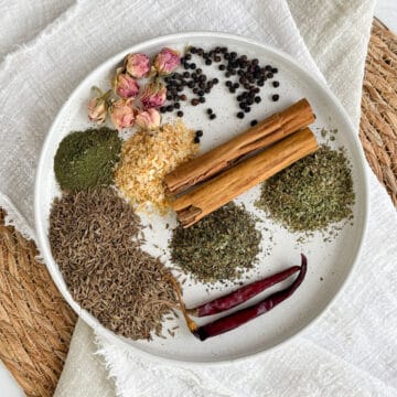 a plate of spiced and herbs to make kamouneh spice