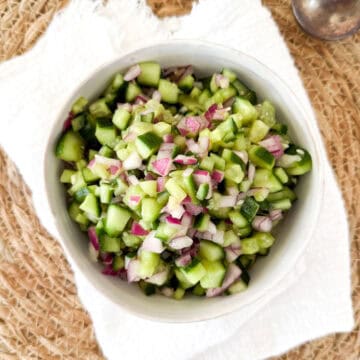 cucumber onion salad with vinegar and sugar in a bowl