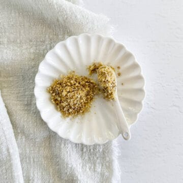 vegan cashew parmesan in a plate with a spoon