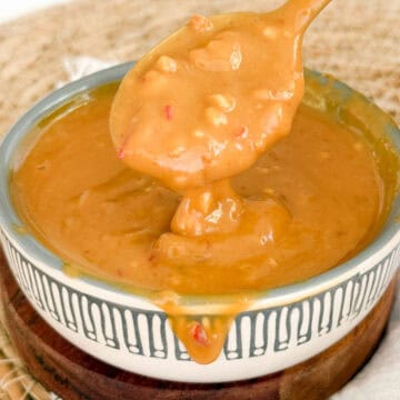 3 ingredient satay sauce in a bowl with a spoon dripping it