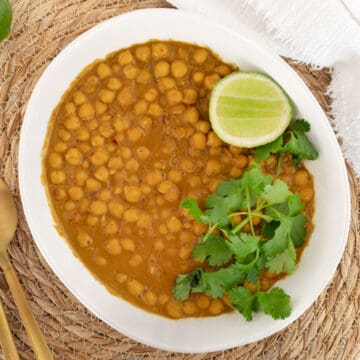 satay chickpeas in a bowl garnished with lime and coriander