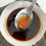 spicy maple syrup that has been strained in a bowl and spoon