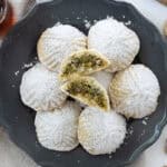 maamoul with pistachios in a plate with one cut open