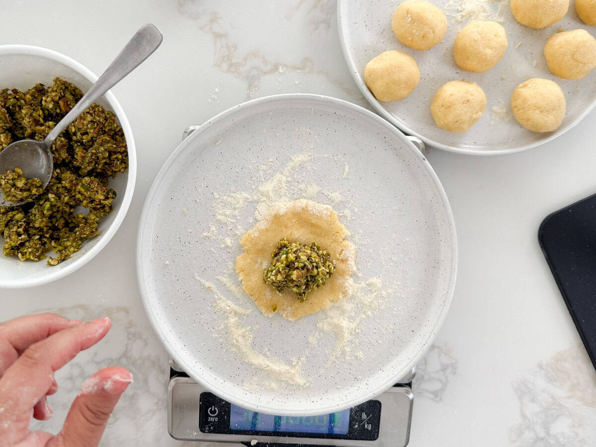 flattened maamoul dough with pistachio filling in it