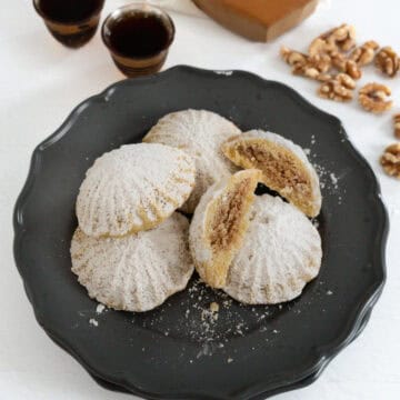 walnut filled maamoul stacked in a plate