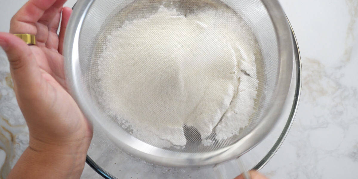 sifting flour into a bowl