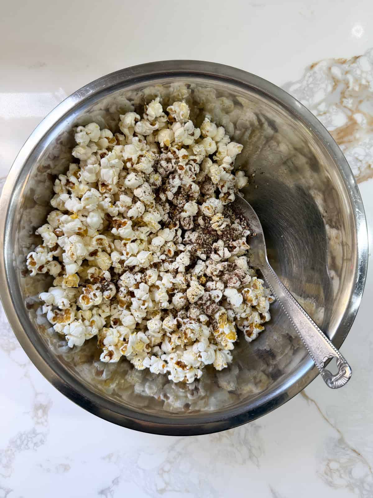 pop corn in a bowl with zaatar seasoning on it