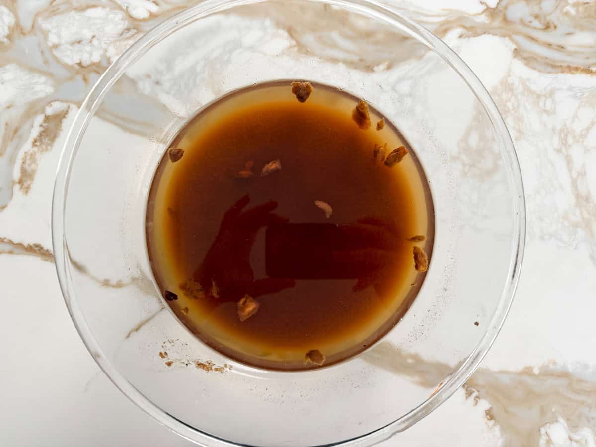tamarind pulp soaking in water in a glass bowl